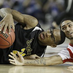 Wichita State's Carl Hall, left, and Louisville's Russ Smith vie for a loose ball during the second half of their NCAA Final Four semifinal showdown Saturday at Atlanta.     