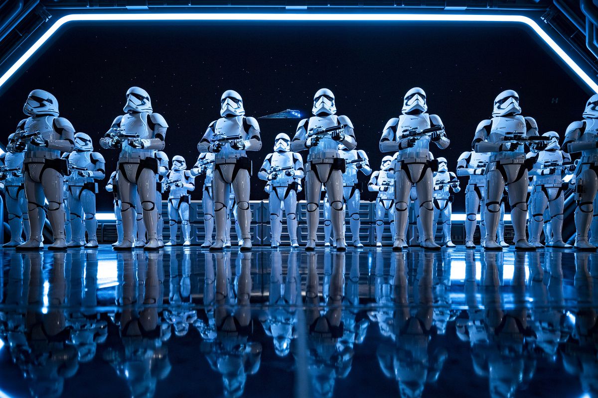 a fleet of stormtroopers stand in the landing bay of a First Order Star Destroyer in Rise of the Resistance