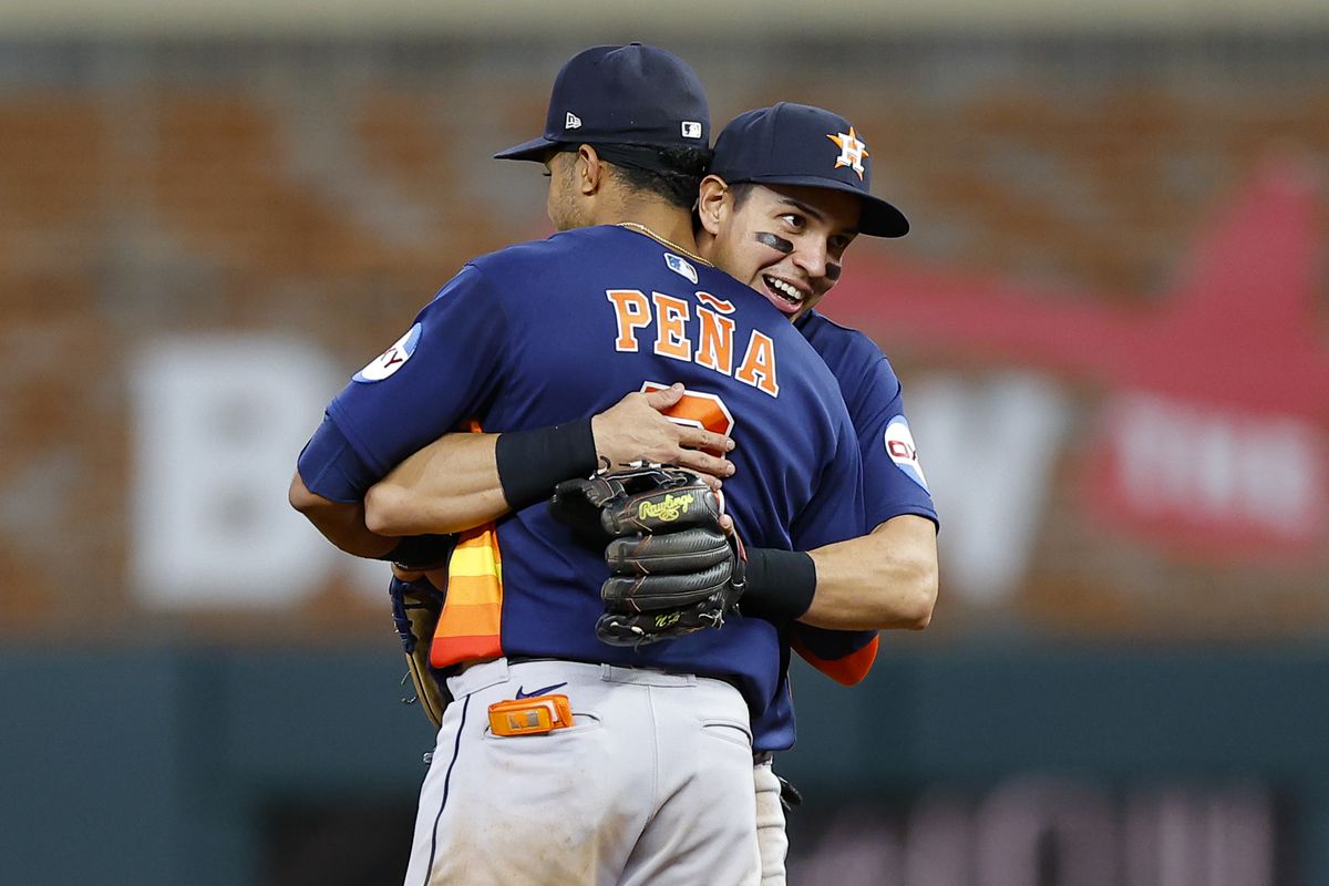 Mauricio Dubon of the Houston Astros reacts with teammate Jeremy Pena at the conclusion of their 6-3 victory over the Atlanta Braves at Truist Park on April 22, 2023 in Atlanta, Georgia.