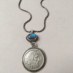 Kelly Sansom, a local artisan from North Salt Lake, creates jewelry using coins from around the world.