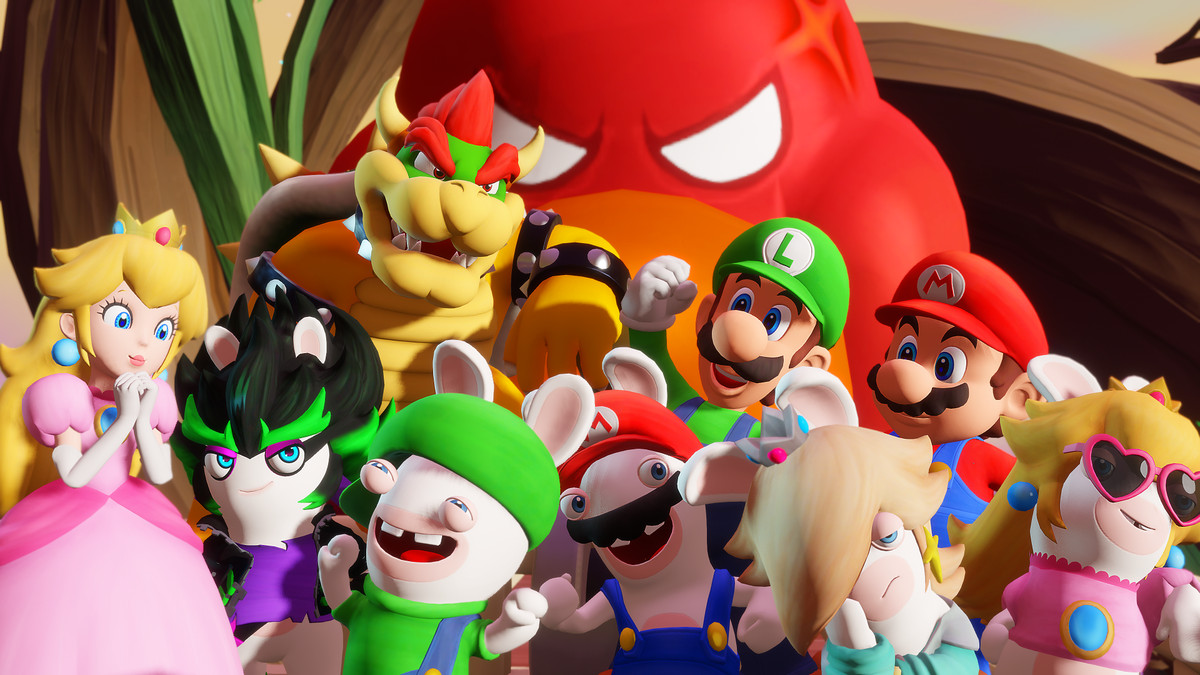 The squamates from Mario + Rabbids Sparks of Hope all cheer in unison, with a giant Spark creature smiling behind them