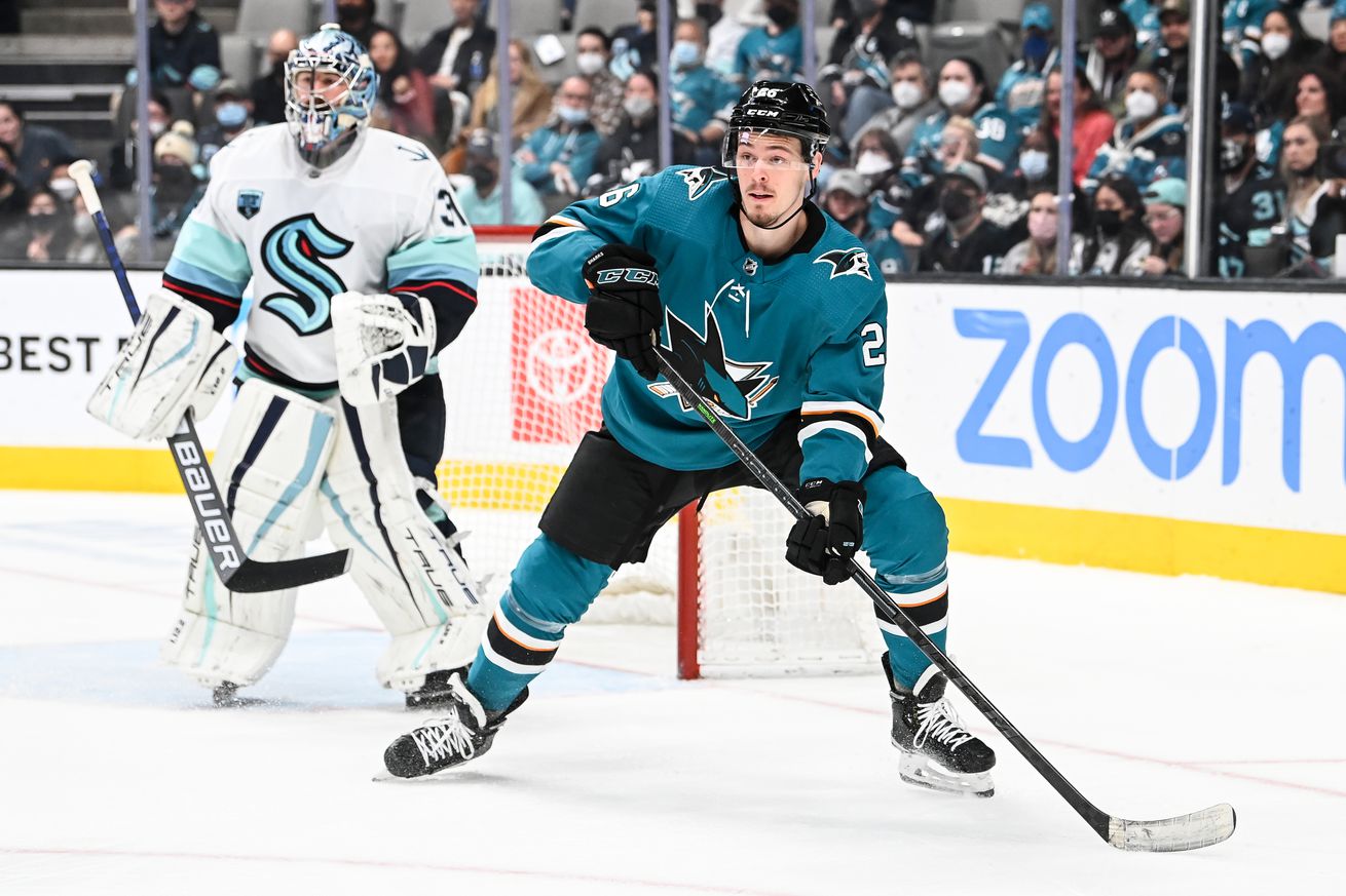 Jasper Weatherby #26 of the San Jose Sharks waits for the pass in front of the net against Philipp Grubauer #31 of the Seattle Kraken at SAP Center on February 27, 2022 in San Jose, California.