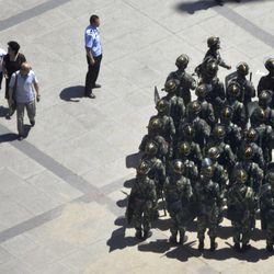 Armed police officers gather at a square in Urumqi, western China's Xinjiang province, Sunday, June 30, 2013. Chinese paramilitary troops began round-the-clock patrols Sunday in the country's northwestern region of Xinjiang following a series of bloody clashes that have killed at least 56 people over the last several months. The order for the patrols by the People's Armed Police was issued by the ruling Communist Party's top law enforcement official, Meng Jianzhu, at an emergency meeting late Saturday in Urumqi. 