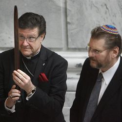The Rev. Ray Waldon of the Cathedral Church of Saint Mark, left,  and Alan Bachman of Chabad Lubavitch pass a peace pipe during a "blessing ceremony" to mark the first day of Interfaith Month at the Utah State Capitol in Salt Lake City on Friday, Feb.1, 2013.