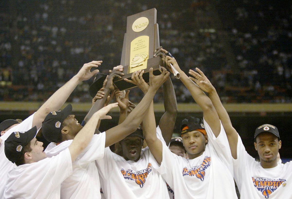 Syracuse celebrates with the trophy