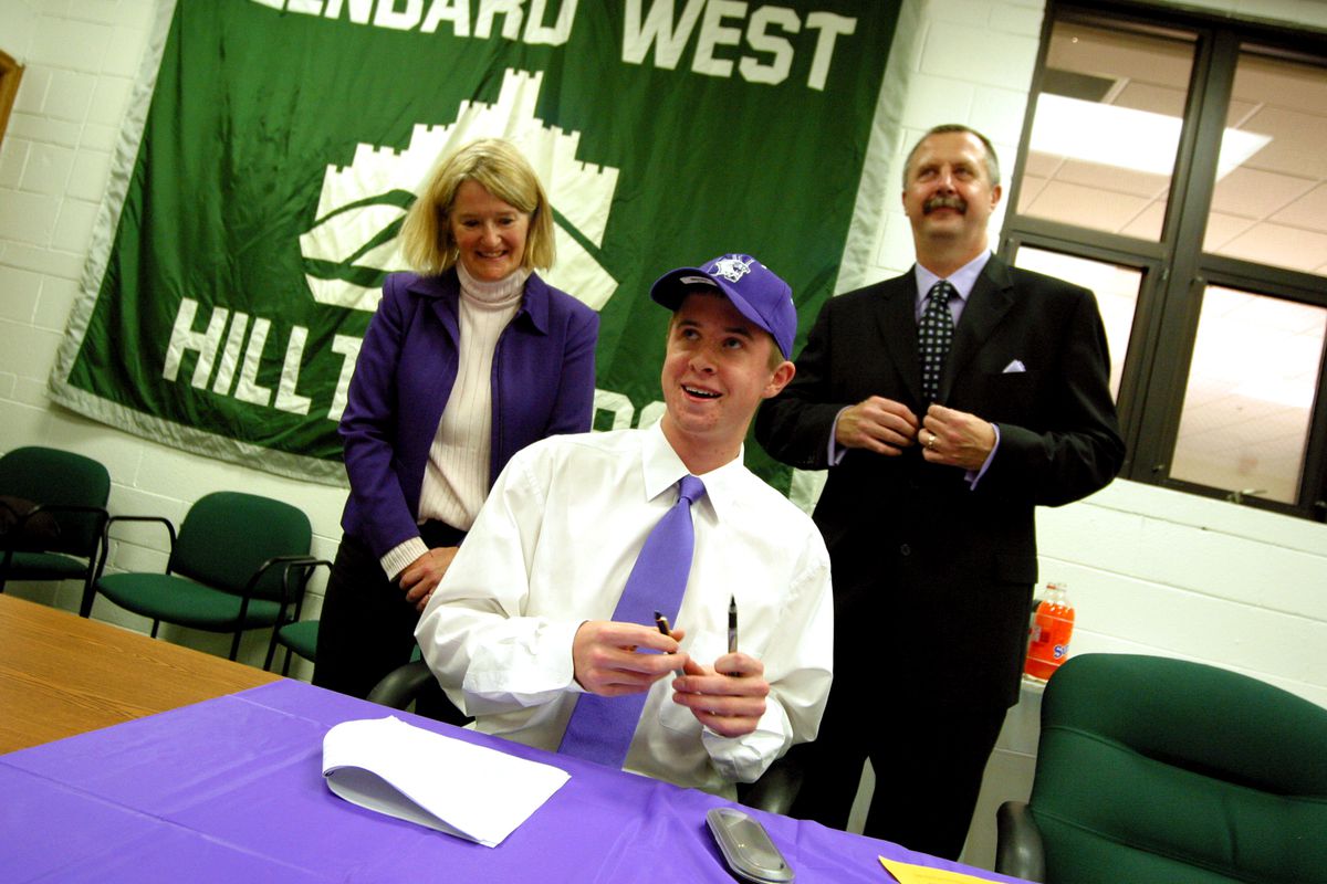 Glenbard West basketball player John Shurna gets ready to sign a national letter of intent with Northwestern.