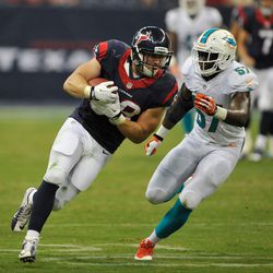 Aug 17, 2013; Houston, TX, USA; Houston Texans tight end Garrett Graham (88) makes a catch for a first down as Miami Dolphins linebacker Josh Kaddu (57) defends during the second half at Reliant Stadium. The Texans defeated the Dolphins 24-17.