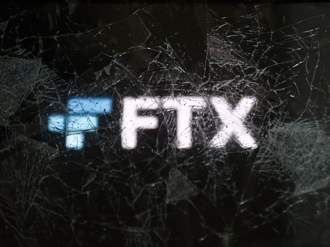 The FTX logo behind broken glass