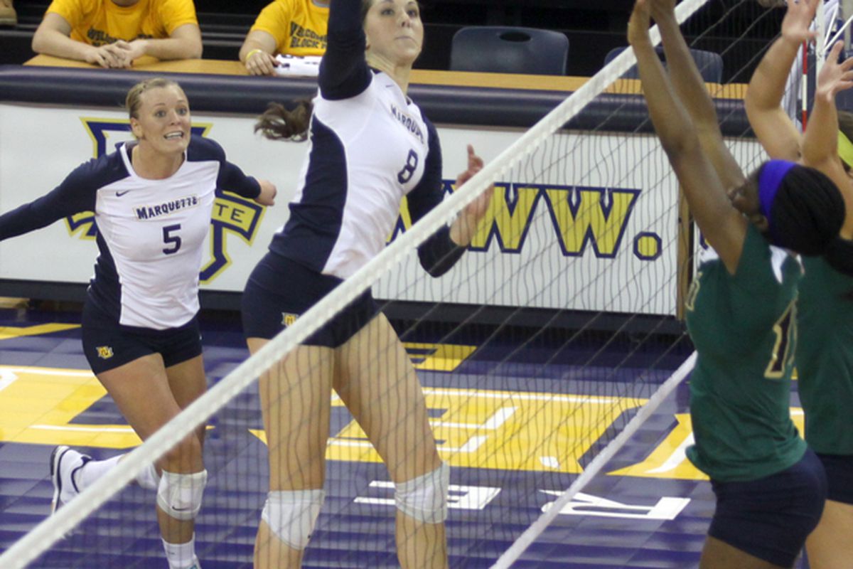 Danielle Carlson (8) goes for a kill against Notre Dame last year. (photo by Mel Pawlyszyn/MarquetteImages.com)