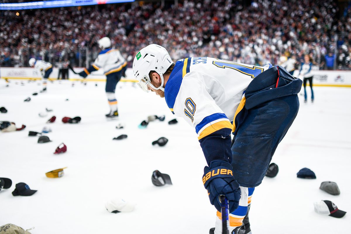 St. Louis Blues center Brayden Schenn (10) looks on as hats are thrown onto the ice in the third period during a Stanley Cup Playoffs round 2 game between the St. Louis Blues and the Colorado Avalanche at Ball Arena in Denver, Colorado on May 25, 2022.