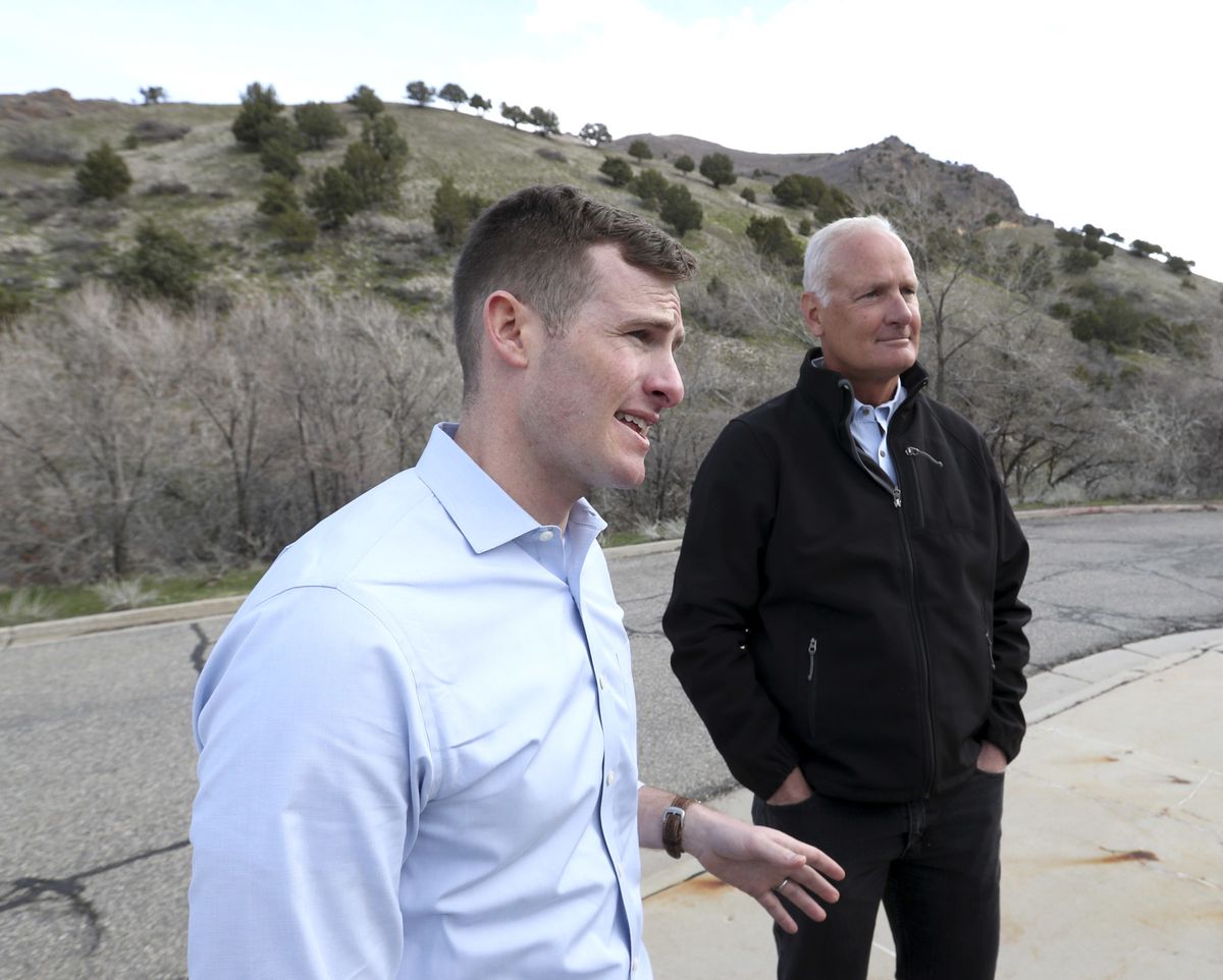 Jesse Dean, deputy director of the Central Wasatch Commission, and John Thomas, project manager for the Utah Department of Transportation, speak at the mouth of Big Cottonwood Canyon in Salt Lake City on Thursday, April 4, 2019. Leaders overseeing the Lit
