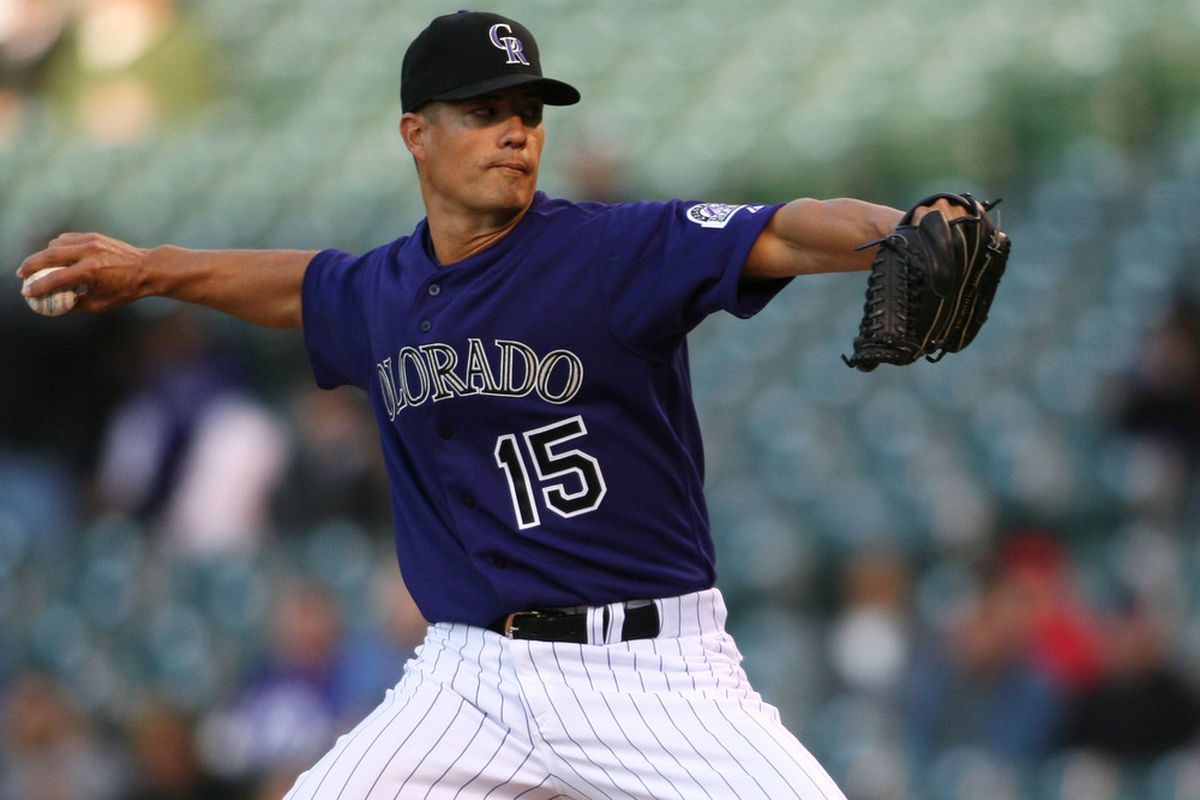 April 16, 2012; Denver, CO, USA; Colorado Rockies pitcher Jeremy Guthrie (15) delivers a pitch during the first inning against the San Diego Padres at Coors Field.  Mandatory Credit: Chris Humphreys-US PRESSWIRE