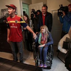 Kim Power Stilson, center, her son, Merrick, left, and husband, Chad, top, check out Merrick's newly remodeled bedroom at their home in Orem on Saturday, Dec. 3, 2016.