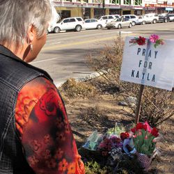 Laura Spaeth looks at a memorial honoring American hostage Kayla Mueller on the corner of courthouse plaza in Prescott, Ariz.,  Tuesday, Feb. 10, 2015.  Islamic State group reported Friday that Muller, whose 18-month captivity had largely been kept secret in an effort to save her, had died in a recent Jordanian airstrike targeting the militants. On Tuesday her parents and U.S. officials confirmed she was dead, although officials said they could not confirm how she died.  