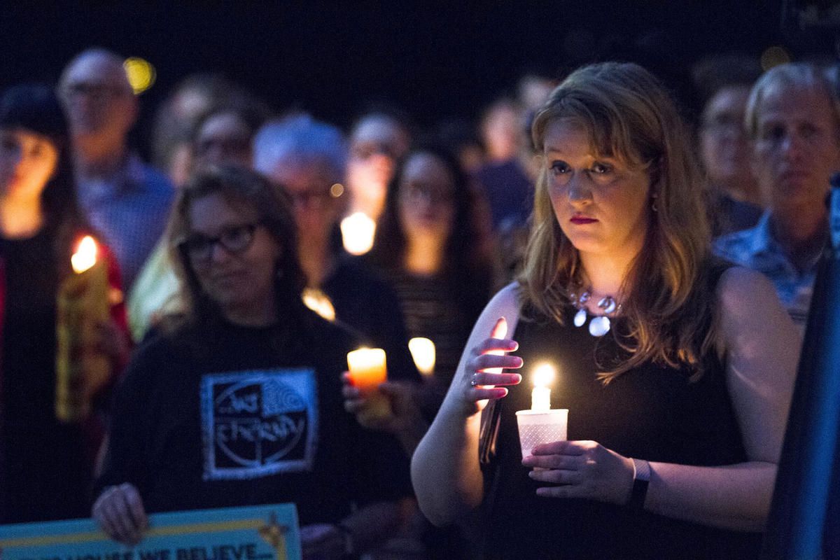 In this Aug. 13, 2107 photo, mourners listen to speakers in Savannah, Ga., at Savannah Taking Action for Resistance's candlelight vigil for the victims in Charlottesville, Va. The vigil took place a day after a white supremacist rally spiraled into deadly
