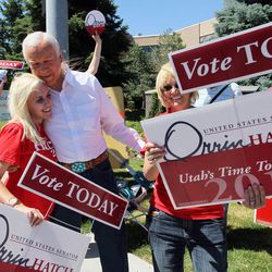 U.S. Senator Orrin Hatch, R-Utah, greets members of his family on a street corner outside his campaign headquarters, Tuesday, June 26, 2012, in Salt Lake City. 