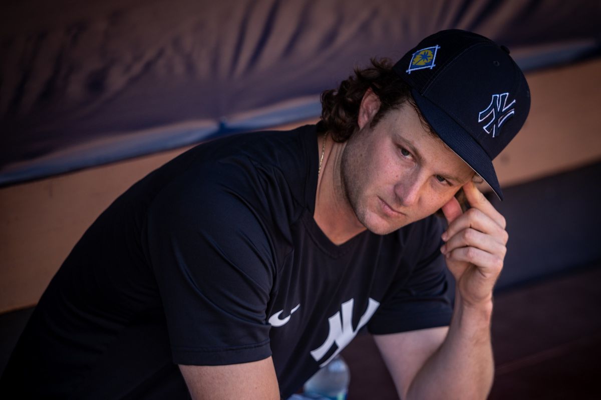 New York Yankees starting pitcher Gerrit Cole sits in team’s dugout at spring training in Tampa
