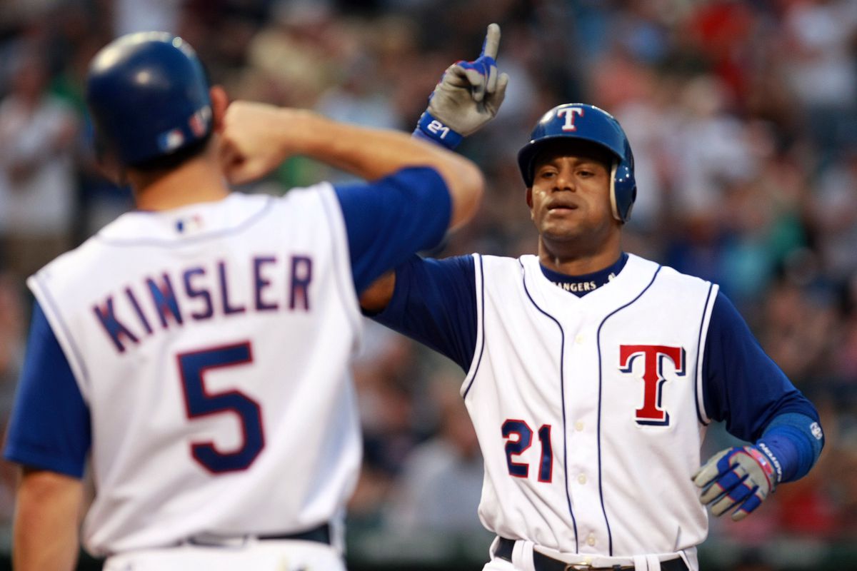 The Texas Rangers’ Sammy Sosa points to the heavens as he ap
