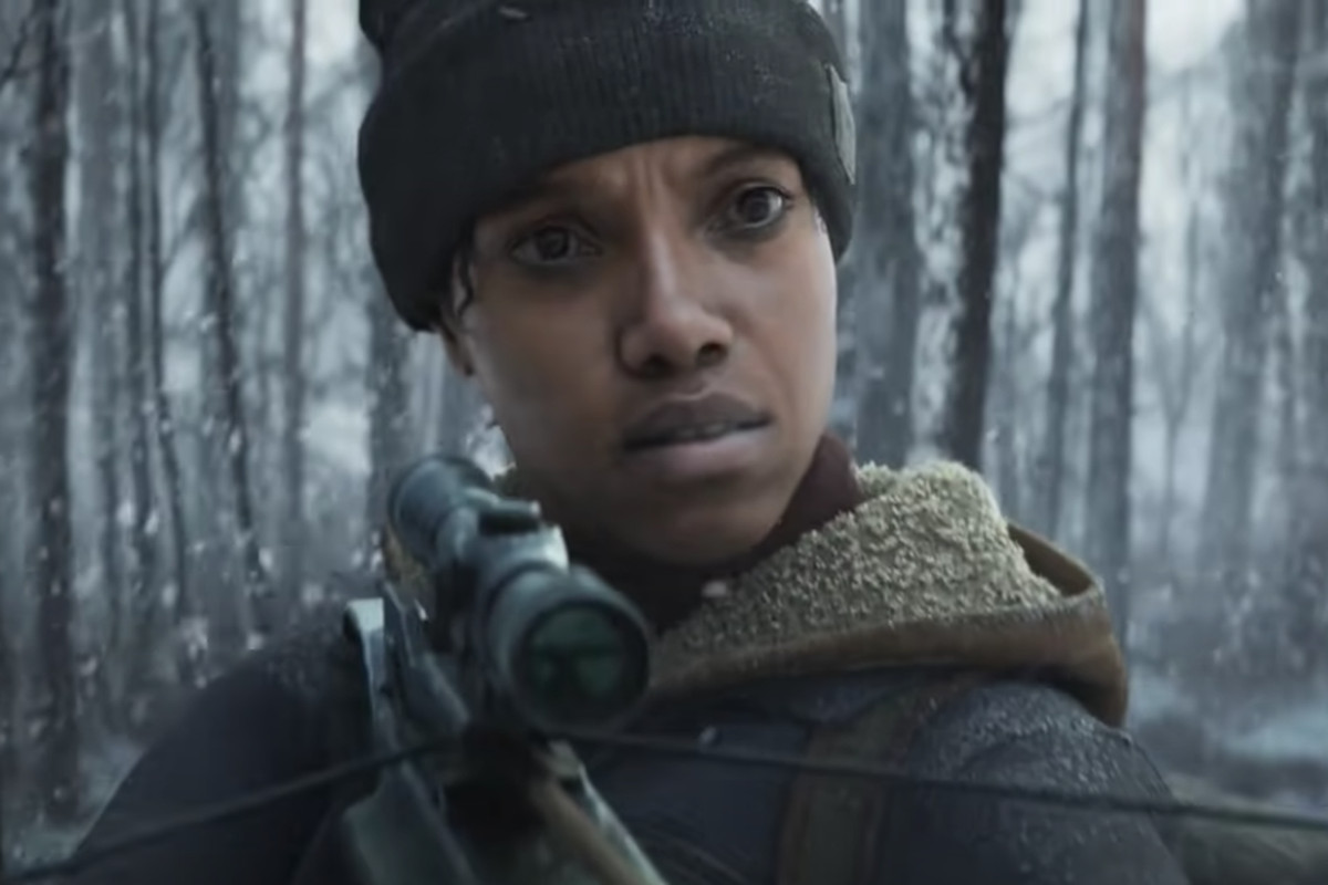Close-up of a woman in a knit cap, who is in the woods hunting, staring incomprehendingly at her prey