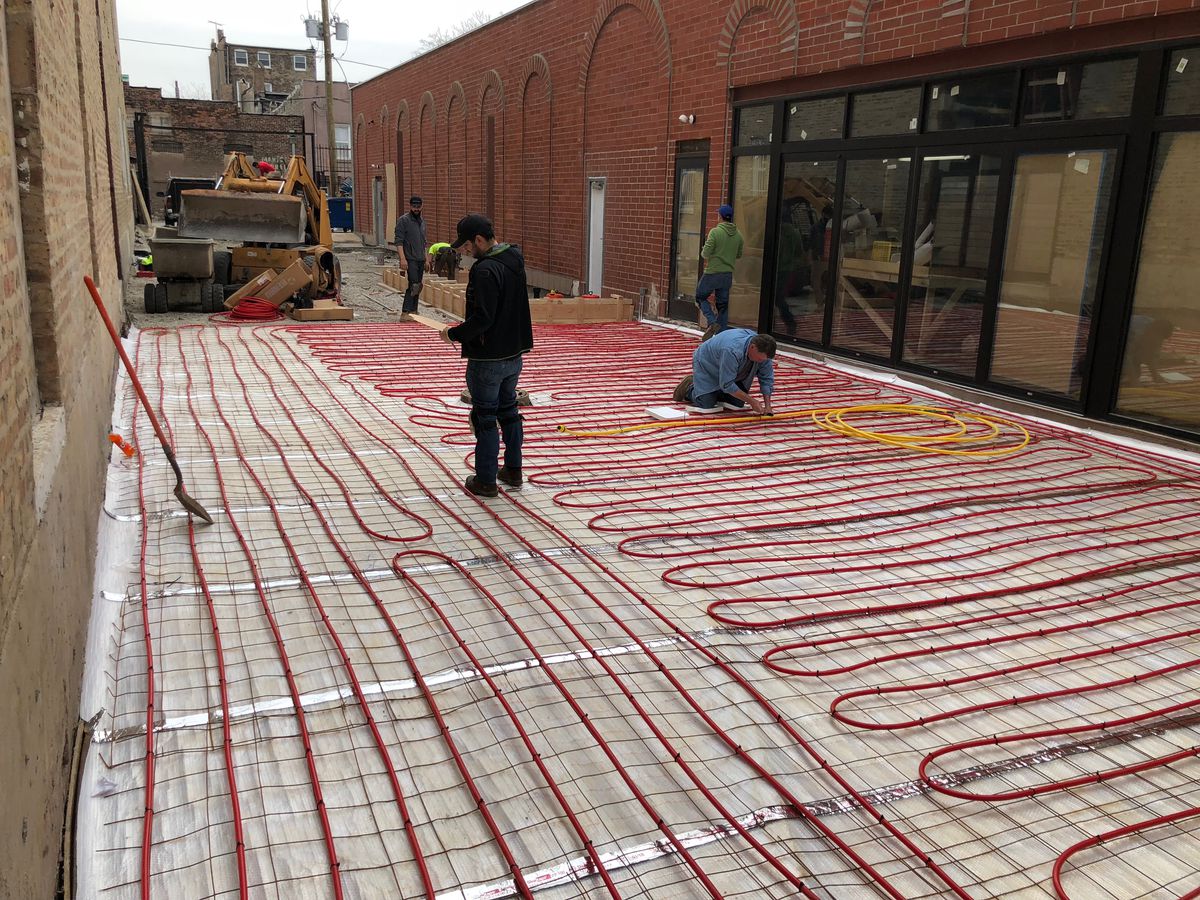 Construction crews putting coils on floors.