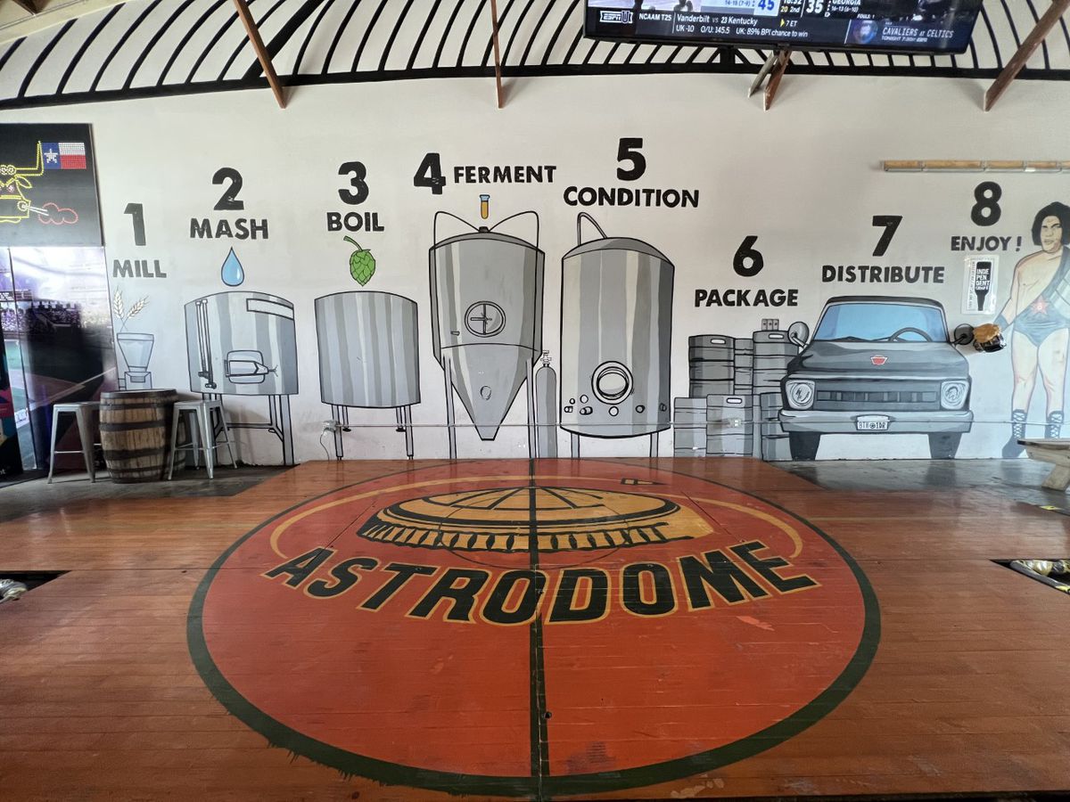The original 1971 NCAA Men’s Championship basketball court flooring from the Astrodome reinstalled at 8th Wonder Brewery.