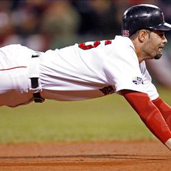 Boston's Mike Lowell slides into third in the fourth inning. Lowell scored later on a sacrifice fly by Jason Varitek and the Red Sox took a 2-0 lead in the World Series.