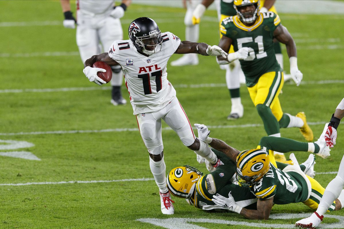 Atlanta Falcons wide receiver Julio Jones is tackled after catching a pass during the second quarter against the Green Bay Packers at Lambeau Field.