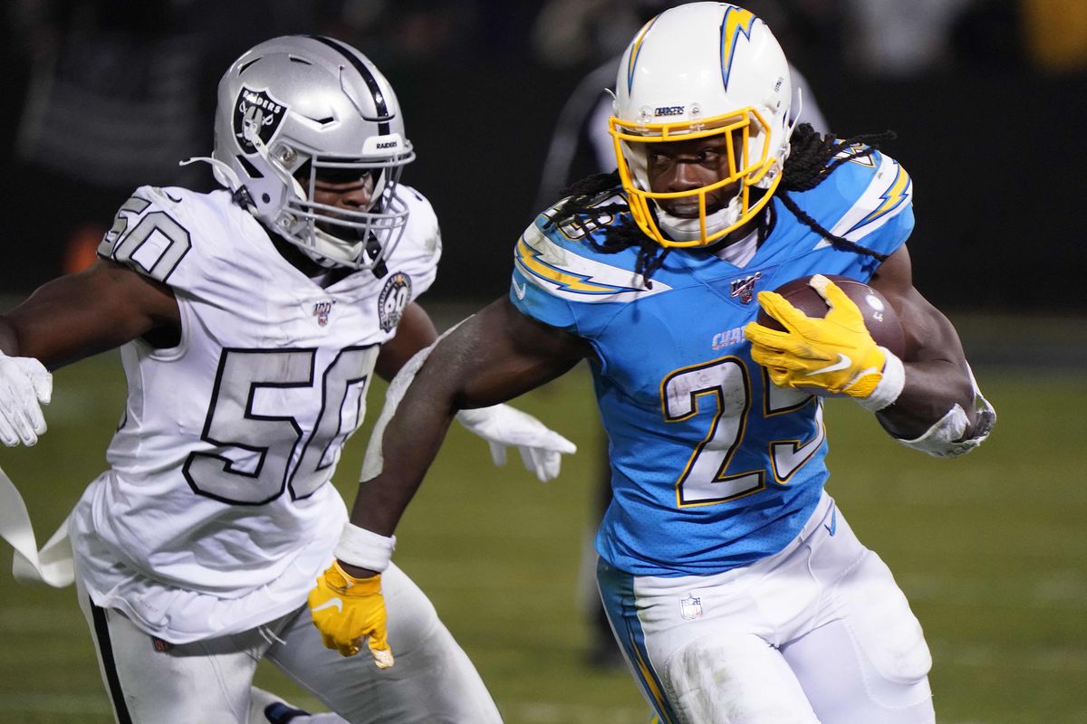 Los Angeles Chargers running back Melvin Gordon is pursued by Oakland Raiders linebacker Nicholas Morrow in the second quarter at Oakland-Alameda County Coliseum.