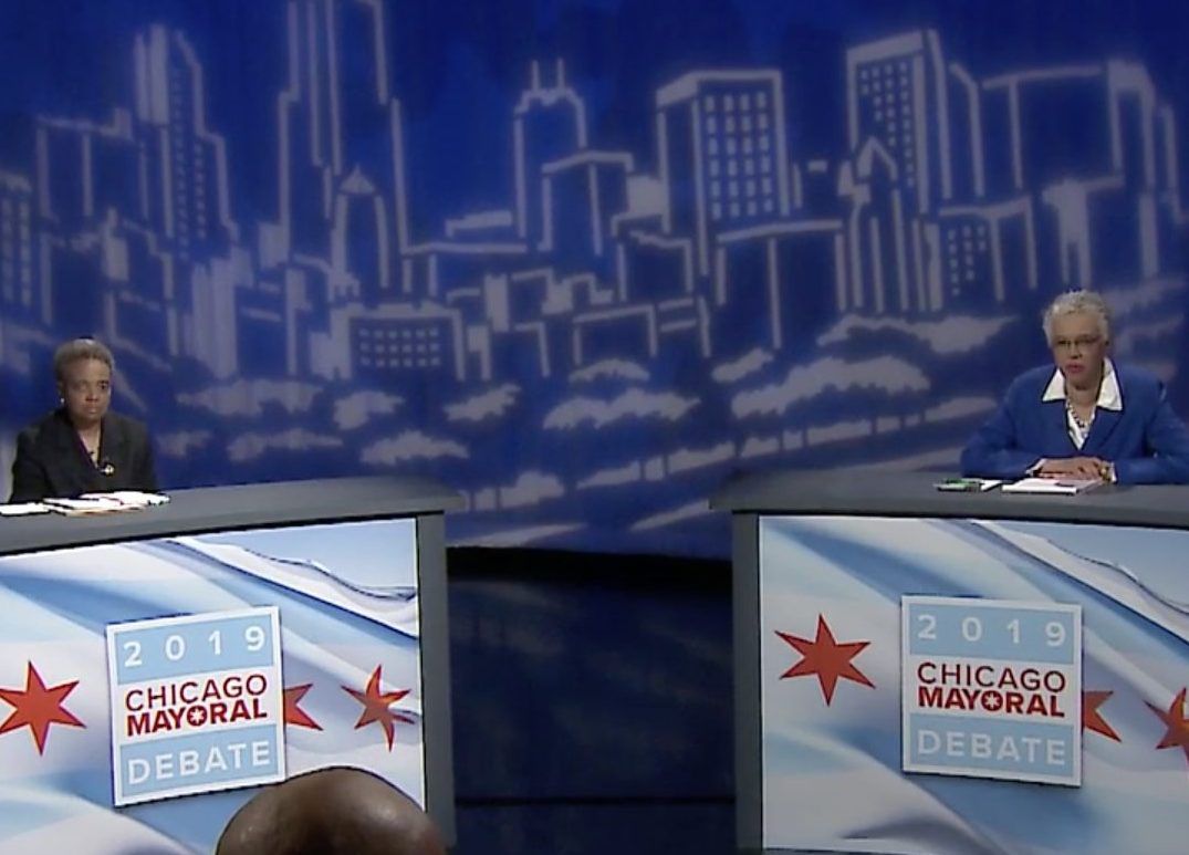 Mayoral candidates Lori Lightfoot, left, and Toni Preckwinkle, right, debate on WGN-TV Monday night. Screen image.