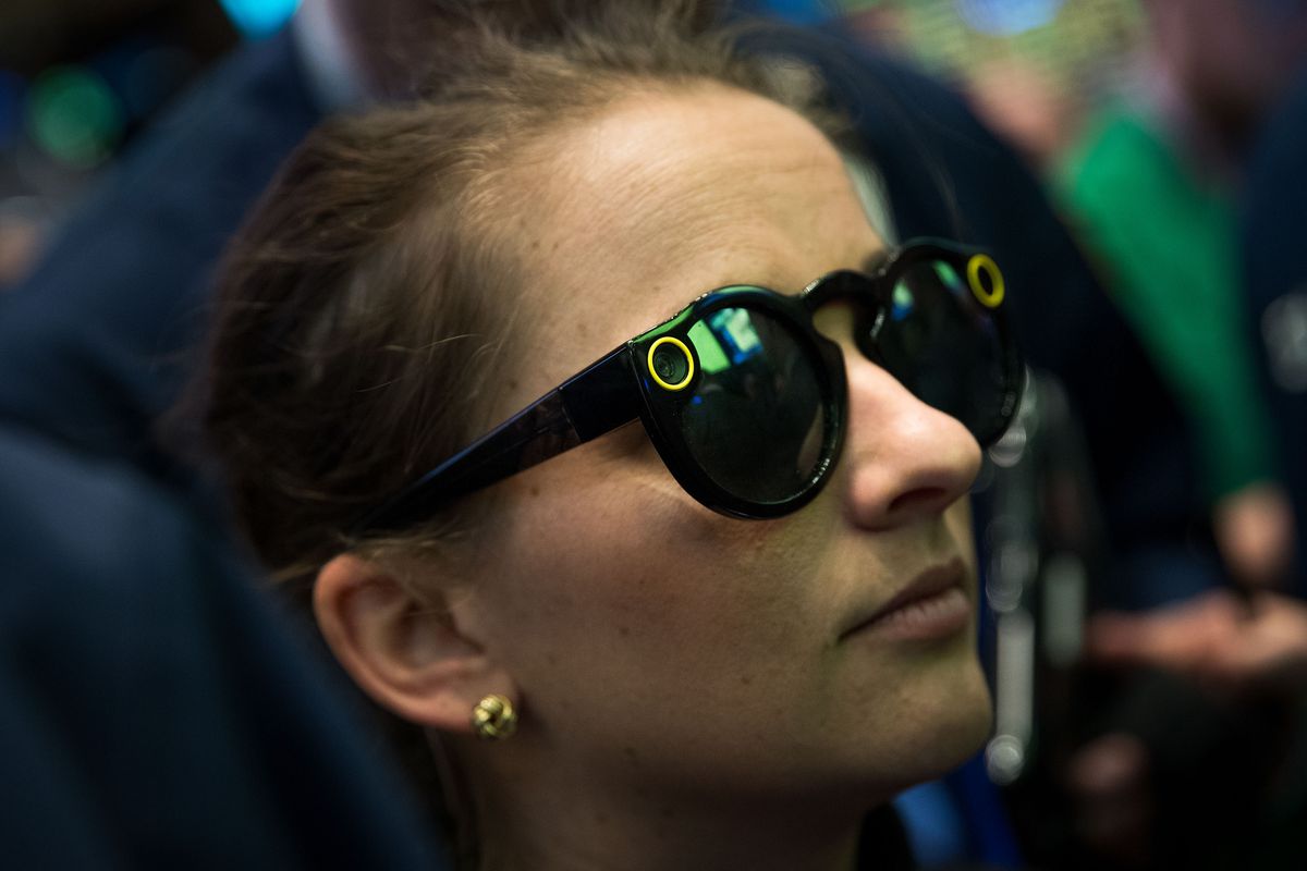 A woman wearing Snap Spectacles