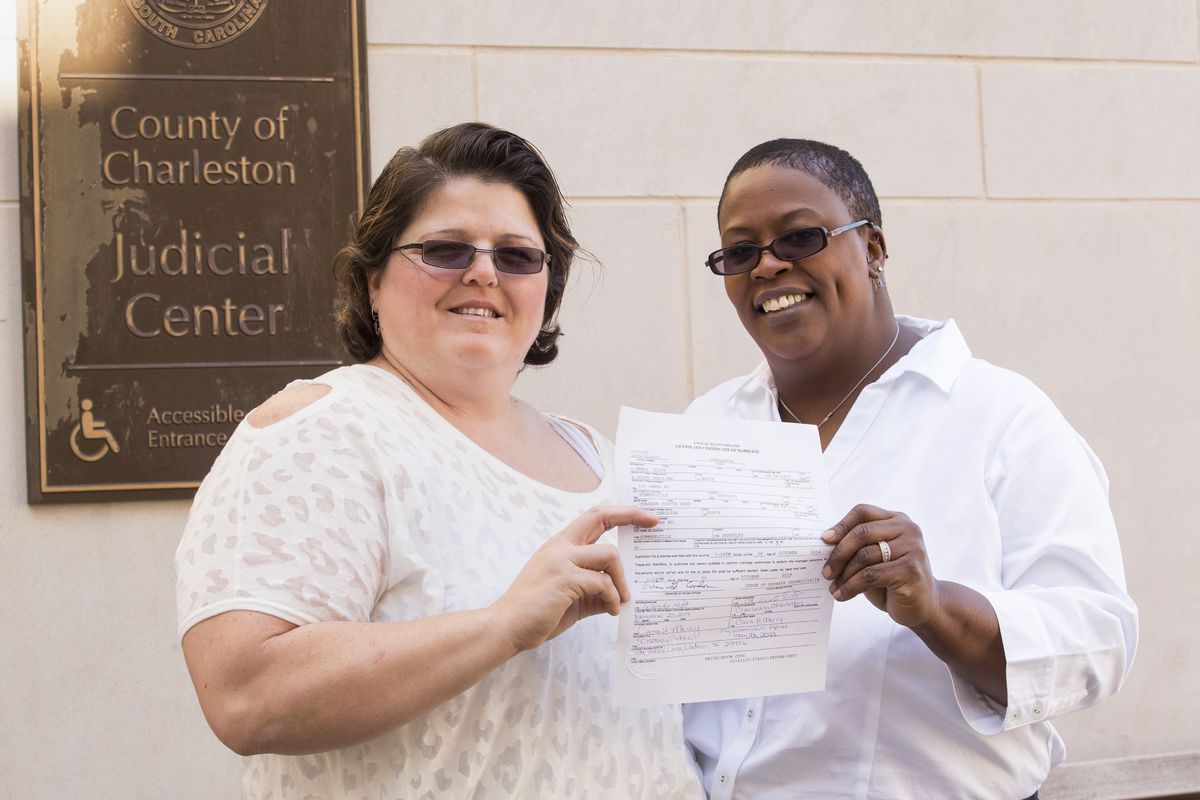 Dawn Deas (R) and her partner Wendy Hilts hold their finalized marriage certificate outside the Charleston Courthouse on November 20, 2014. They've been together for 14 years.