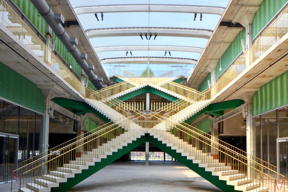 the interior of a building with in interesting, X-shaped stairwell
