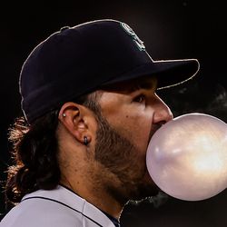 Eugenio Suarez #28 of the Seattle Mariners blows a bubble during the third inning against the Milwaukee Brewers at T-Mobile Park on April 18, 2023 in Seattle, Washington.