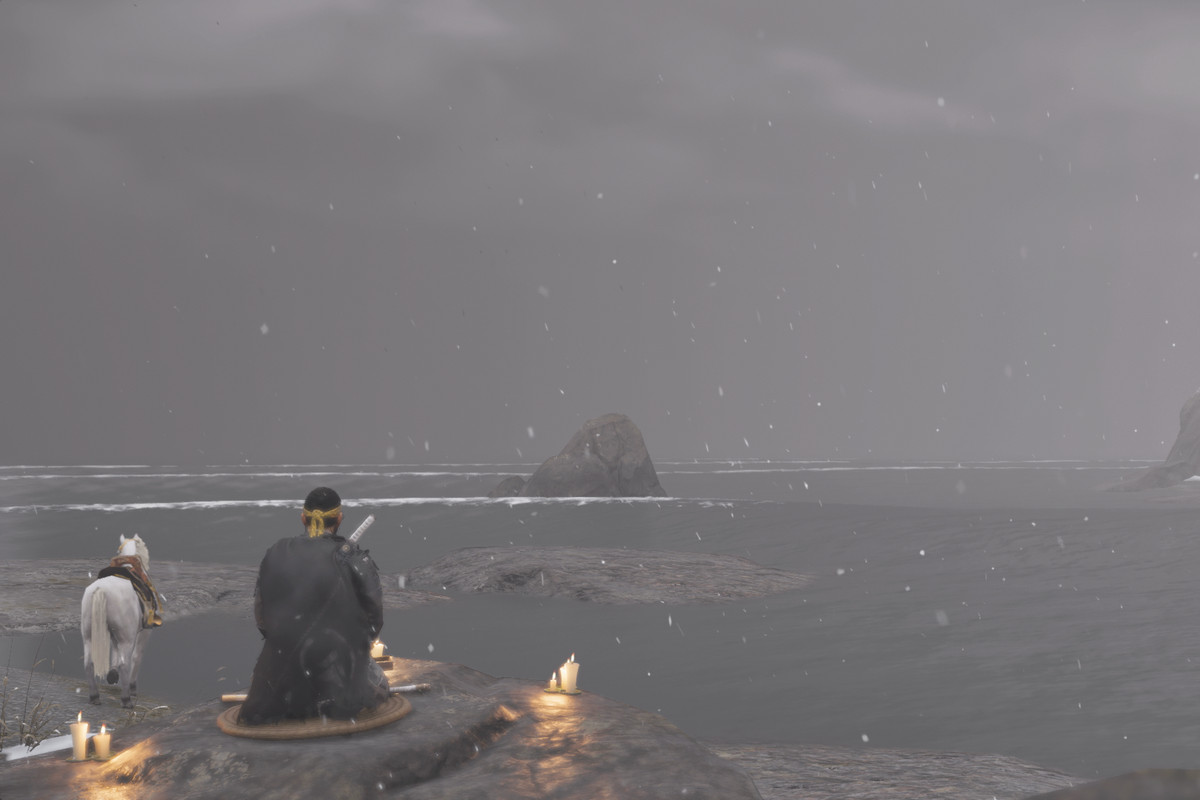 The main character of Ghost of Tsushima and sits and writes a haiku