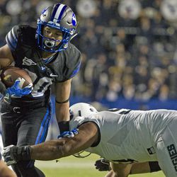 Brigham Young running back KJ Hall (20) sheds a Utah State tackler during an NCAA college football game in Provo on Saturday, Nov. 27, 2016. Brigham Young defeated in-state foe Utah State 28-10.
