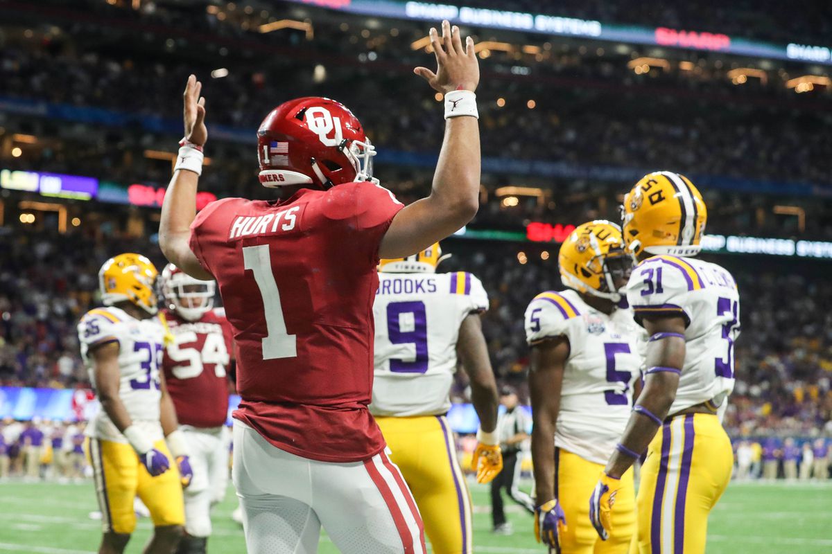 Oklahoma Sooners quarterback Jalen Hurts reacts after scoring a touchdown during the third quarter of the 2019 Peach Bowl college football playoff semifinal game against the LSU Tigers at Mercedes-Benz Stadium.