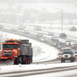 Snowplows clear 12300 South in Riverton as snow falls along the Wasatch Front on Friday, Dec. 10, 2021.