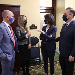 Gov. Spencer Cox, left, talks with his wife, Abby Cox, second from left, Lt. Gov. Deidre Henderson, center, and Henderson’s husband, Gabe Henderson, right, before giving his first State of the State address at the Capitol in Salt Lake City on Thursday, Jan. 21, 2021.