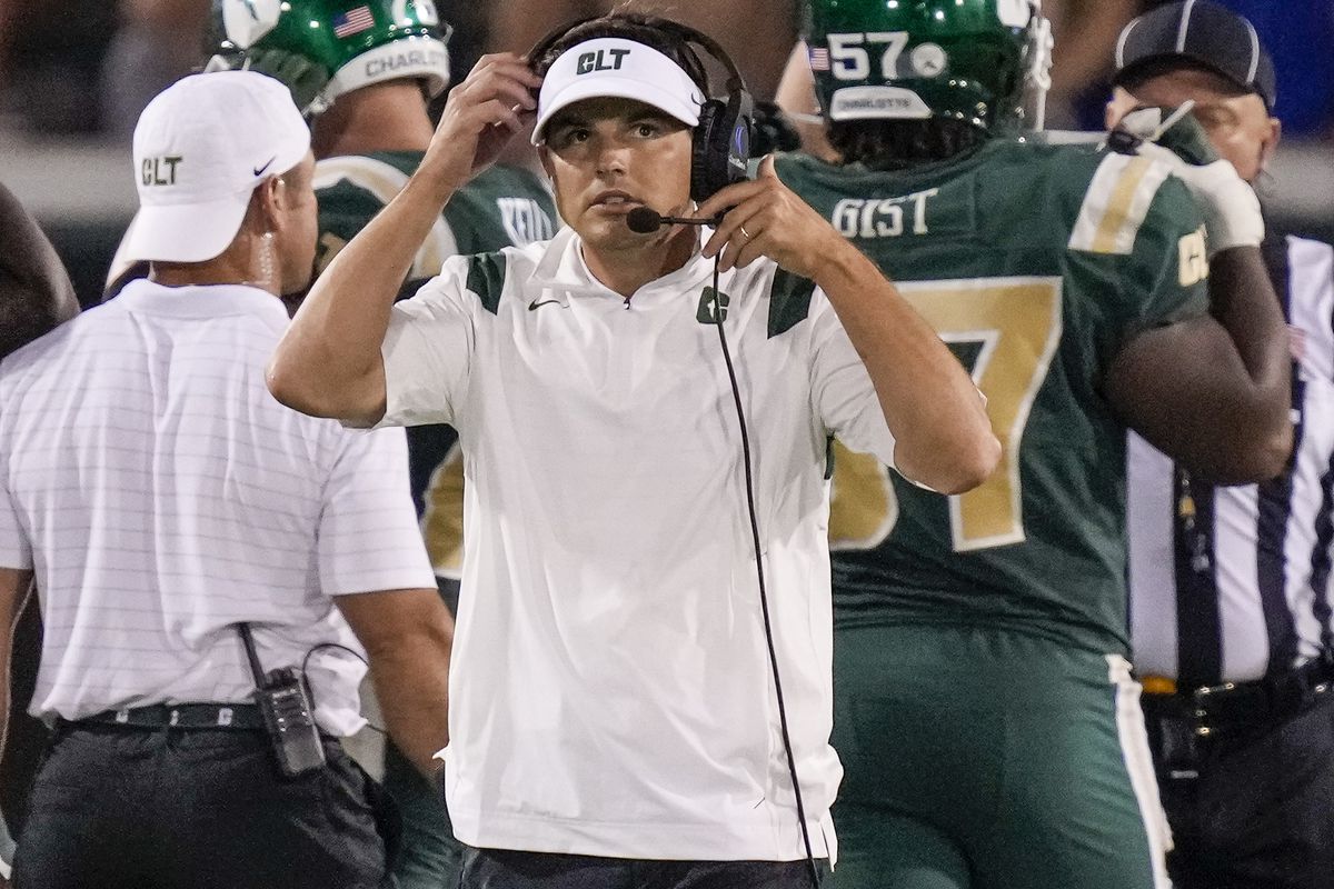 Charlotte 49ers head coach Will Healy looks at the scoreboard during the second half against the Duke Blue Devils at Jerry Richardson Stadium.