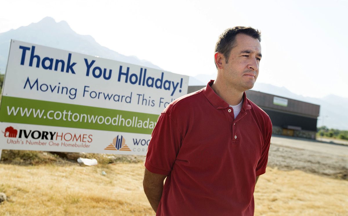 Paul Baker, a member of Unite for Holladay, stands outside the property of the former Cottonwood Mall site in Holladay on Thursday, Sept. 6, 2018.