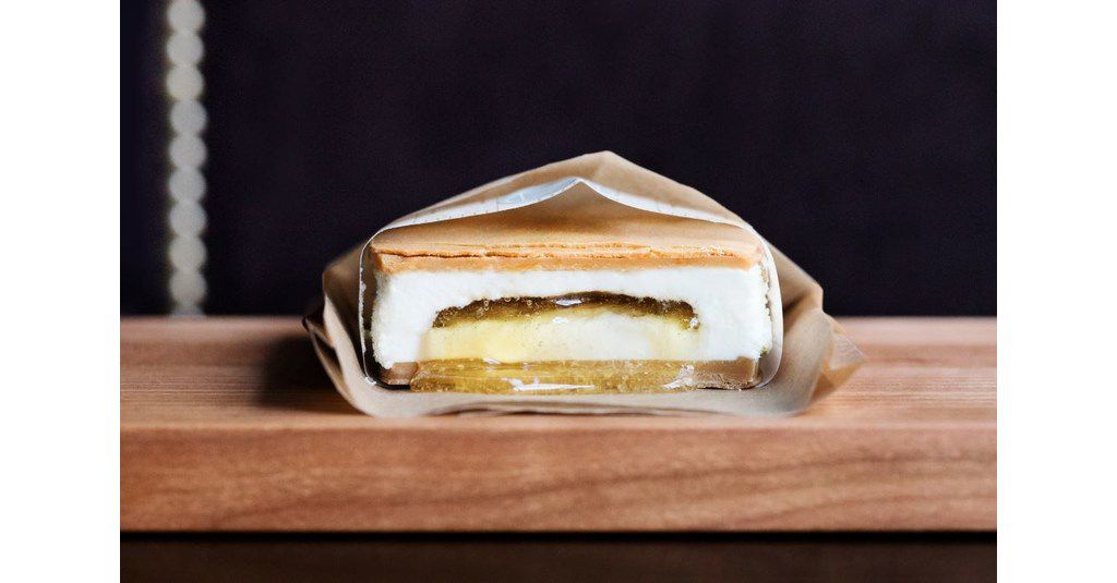 An ice cream sandwich in a paper wrapping