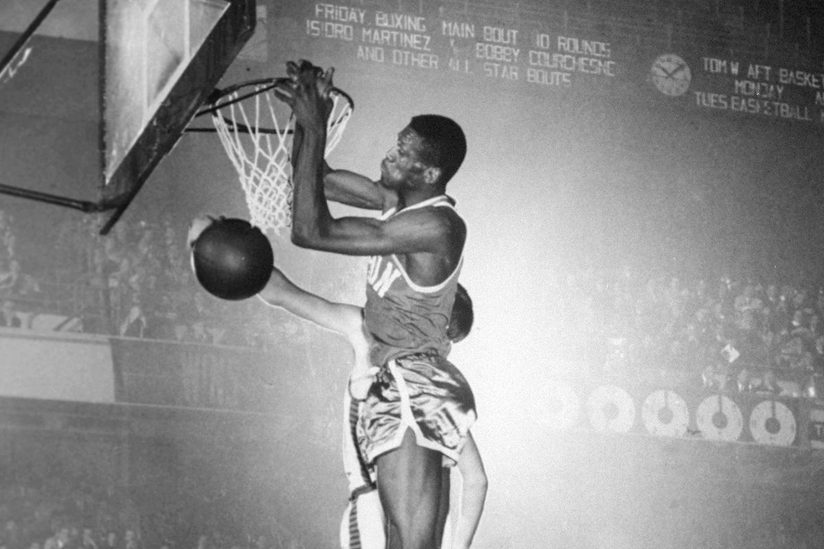 Bill Russell of the Boston Celtics goes rim high for a score