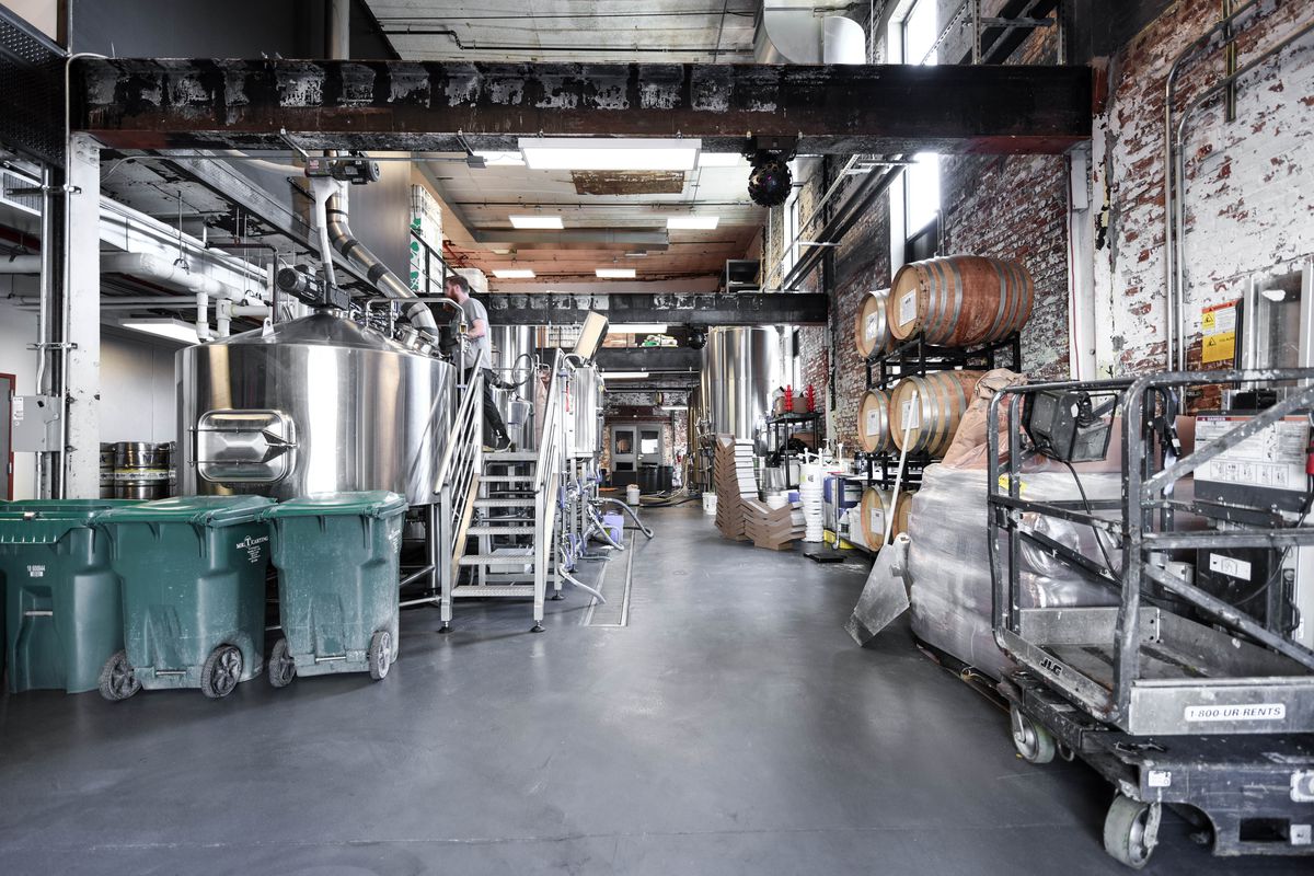 The inside of Evil Twin Brewing with massive stainless steel tanks