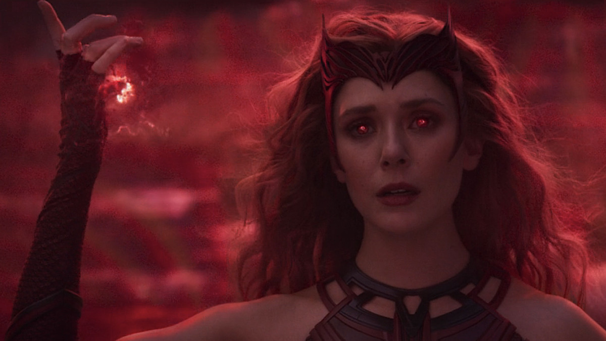 Elizabeth Olsen in WandaVision in full Scarlet Witch mode, with glowy red hands and eyes