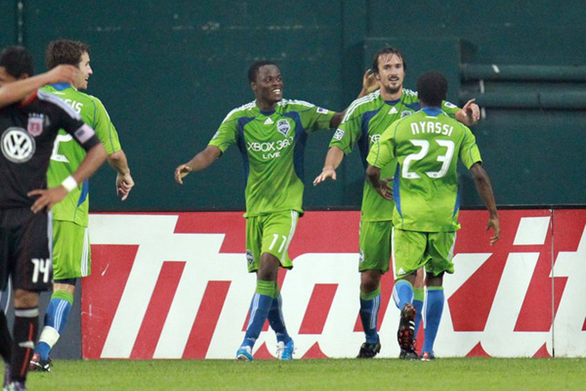 WASHINGTON - JULY 15: Roger Levesque #24 of Seattle Sounders FC celebrates his goal with Sanna Nyassi #23 against # of D.C. United at RFK Stadium on July 15 2010 in Washington DC. (Photo by Ned Dishman/Getty Images)