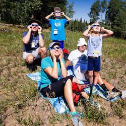 Mike Platz, left, Josh Platz, Debbi Platz, Paul Beaufait and Abbi Platz all look at the eclipse in Park City Mountain in Park City on Monday, Aug. 21, 2017. The partial eclipse was at 90 percent of totality in Park City.