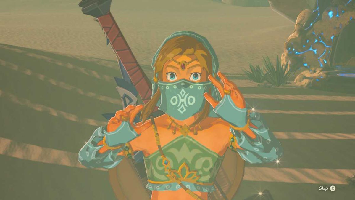 Link dressed as a Gerudo woman in The Legend of Zelda: Breath of the Wild. He is wearing a blue veil, gloves, and a crop top.