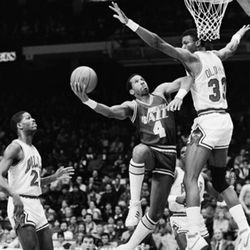 Utah Jazz forward Adrian Dantley elbows his way through the defense of Chicago Bulls' Jawann Oldham during the first half of NBA action in Chicago December 21, 1985. (AP Photo/Charlie Bennett)