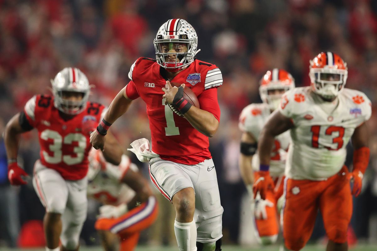Quarterback Justin Fields of the Ohio State Buckeyes scrambles with the football during the PlayStation Fiesta Bowl against the Clemson Tigers at State Farm Stadium on December 28, 2019 in Glendale, Arizona.