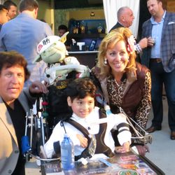 Dominic Cumo, his parents Shawnee and Matteo, and Yoda with his new wheelchair